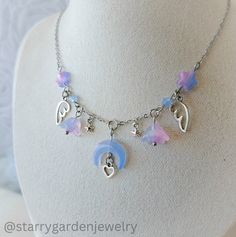 💜Pastel Moon and Flowers Charm Necklace🌙 Featuring pastel-hued star and flower beads, delicate angel wings, and a charming crescent moon centerpiece adorned with a tiny heart ✨️  ➤ 𝘈𝘣𝘰𝘶𝘵 𝘖𝘶𝘳 𝘕𝘦𝘤𝘬𝘭𝘢𝘤𝘦𝘴 ❀ Please note that each necklace is meticulously handmade, resulting in slight variations in shapes and patterns from the product images. ❀ Additionally, colors may vary slightly from what you see on your screen, due to differences in screen settings. ➤ 𝘑𝘦𝘸𝘦𝘭𝘳𝘺 𝘊𝘢𝘳𝘦 ❀ Necklace Fairycore, Cottagecore Necklace, Moon And Flowers, Fairycore Necklace, Pastel Moon, Diy Collier, Celestial Necklace, Neck Jewellery, Flower Beads