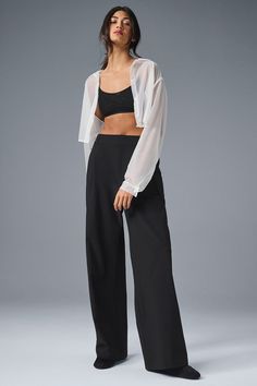 A shorter version of our best-selling Pursuit Trousers, this modern fit is the ultimate closet staple. They have a high-rise waistband (flat in front and stretchy in back), tailored details (belt loops and pleats), and a relaxed, wide-leg fit. Plus, they’re made from a lightweight, stretch-infused fabric that looks sleek and feels totally comfortable. You'll go straight from work to your weekend plans with just a change of shoes. Versatile Alo Yoga Bottoms, Versatile Solid Color Alo Yoga Bottoms, Flattering Black Bottoms For Work, Fitted Alo Yoga Bottoms, Chic Bottoms With Wide Waistband For Work, Chic Workwear Bottoms With Wide Waistband, Chic Fitted Alo Yoga Bottoms, Black Cropped Elastane Bottoms, Chic Stretch Pantsuit For Night Out