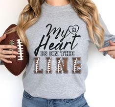 Personalized Football shirt, great for football moms, girlfriends and fans everywhere, mom and dad will love them and grandma won't wear any other shirt to a football game.  * Designed and printed and shipped in the USA                   Thank you - we are incredibly grateful for your support of our small business.  *No rubbery vinyl, dull color sublimation, or cracking scratchy screen print. Our designs are printed using the highest quality professional direct to garment (DTG) process. Our swea Personalized Sporty Tops For Sports, Sporty Personalized Tops For Sports Events, Personalized Game Day Tops With Team Spirit, Personalized Crew Neck T-shirt For Game Day, Sporty Personalized T-shirt For Game Day, Personalized Sporty T-shirt For Game Day, Sporty Personalized T-shirt For Sports Events, Sporty Personalized T-shirt For Sports, Casual Personalized Tops For Game Day