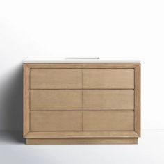 a white sink sitting on top of a wooden cabinet