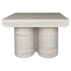 a white marble table with two columns on the top and one column at the bottom