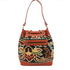 a handbag with an orange leather handle and multicolored pattern on the front