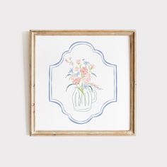 a drawing of flowers in a vase on a white wall above a wooden framed frame