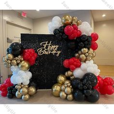 a happy birthday balloon arch with red, white and black balloons