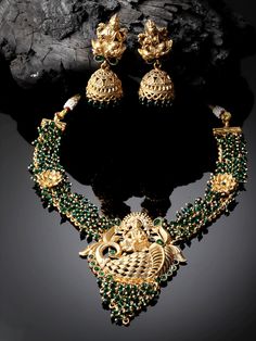 Gold-Plated Stones Studded Beaded Temple Jewelry Necklace With Earrings Set/Bollywood Jewelry/Navratri Diwali Jewelry/Statement Jewelry Main Stone: Artificial Stone Plating: Golden Plated Stone Cut : Round Color : Green Metal: Alloy Closure: Post and Back Size & Fit: Length of Necklace: 22 cm Length of Earrings: 5.5 cm each Material & Care: Alloy and Artificial beads Care Instructions: Wipe your jewellery with a soft cloth after every use Always store your jewellery in a flat box to avoid accidental scratches Keep sprays and perfumes away from your jewellery Do not soak your jewellery in water,Clean your jewellery using a soft brush,Dipped in jewellery cleaning solution only ADIVA Jewelry set is the identity of Indian women and a symbol of grace. These earrings include an insight of crude Diwali Chandbali Jewelry Sets With Latkans, Festive Eid Temple Jewelry Sets, Festive Jewelry Sets With Latkans For Eid, Chandbali Temple Necklace For Eid, Festive Chandbali Temple Necklace For Eid, Festive Temple Necklace For Eid, Eid Festive Chandbali Temple Necklace, Eid Festive Temple Necklace, Festival Peacock Design Jhumkas For Parties