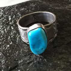 Navajo Turquoise Stone Ring In Raised Bezel Setting. Wide Width 1/2” Band Has Great Scalloped Stamping Design. Attractive Design, Handcrafted And Signed By The Artist Lly. Stone Is 3/4” X 3/8” Please Use The Photos For More Ring Details The Turquoise Stone Is Fractured But Stable. The Ring Would List At $149 But Is Priced Lower Due To The Fracture Size 11 9.29 Grams Weight Stamped Sterling Hallmark Lly Native American Never Worn Condition From Vintage 80’s Collection Mens Sterling Silver Jewelry, Turquoise Stone Ring, Native American Rings, Navajo Turquoise, Vintage Navajo, Sterling Silver Mens, Stamp Design, Stone Ring, Turquoise Stone