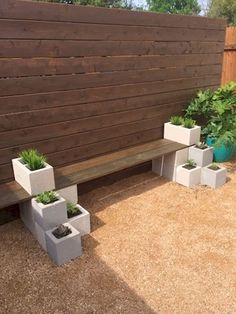 a wooden bench sitting next to two planters