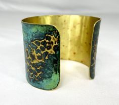 These unique, hand-formed copper and brass cuff bracelets with vibrant patinas create stunning accents to your personal style. Dress up or down- either way you'll be wearing an adornment that will turn heads, start conversations, and delight the eye of the beholder. This is a hammered cuff with bright brass peeking through a vivid marbled green/blue patina. Please note that patina colors will look different depending on the screen/device you view them on. This is a small cuff- see measurements b Unique Brass Cuff Bracelet, Handmade Brass Cuff Bracelet In Wearable Art Style, Handmade Brass Cuff Bracelet Wearable Art, Patina Brass Bangle Bracelet, Brass Bangle Bracelet With Patina, Artistic Gold Copper Bracelets, Unique Hammered Brass Cuff Bracelet, Adjustable Patina Cuff Bracelet, Adjustable Patina Cuff Bracelet Wearable Art