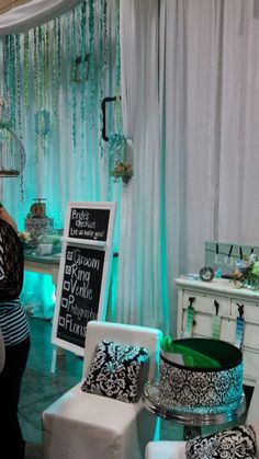 a woman standing in front of a table with cakes on it