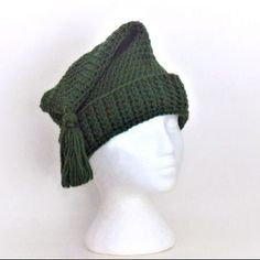 a white mannequin head wearing a green knitted hat