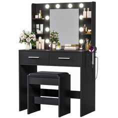 a black vanity with lights and stool