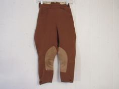 "Vintage 1950s jodhpurs, horse riding pants or motorcycle pants. Made of rust brown wool twill. Has a zip side, two waist pockets and button cuffs. Made by Brittany Riding Apparel. Size small or extra small. Actual measurements are: 21.75\" at the waist 37\" hips 18.5\" inseam 29.5\" overall length In good condition with some spots." Fitted Breeches With Pockets For Fall, Fall Fitted Breeches With Pockets, Fitted Vintage Brown Bottoms, Fitted Breeches With Belt Loops For Fall, Fitted Fall Breeches With Belt Loops, Vintage Fitted Breeches With Pockets, Fitted Vintage Breeches With Pockets, Fitted Full-length Riding Breeches, Fitted Full-length Riding Pants