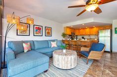 a living room filled with furniture and a ceiling fan