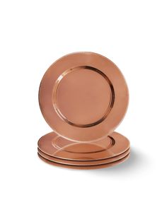 four rose gold plates stacked on top of each other, with one plate in the middle