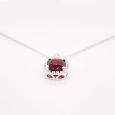 This deep red cushion-cut garnet is breathtaking and set beautifully within a diamond halo. This necklace was designed with a matching ring as shown in the pictures. These two make a stunning set that is the perfect addition to any jewelry collection. The necklace looks great on any woman as it will match their lipstick and lips! The details for this beautiful necklace are listed below:Metal Quality: 14K White GoldPendant Style: Garnet Diamond HaloDiamond Number: 20Diamond Shape: Round Brilliant Red Garnet Necklace, Red Cushions, Matching Ring, Garnet Pendant, Garnet Necklace, Matching Rings, Diamond Halo, Red Garnet, Cushion Cut