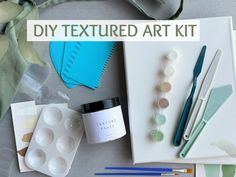 an assortment of crafting supplies on a table with text overlay that reads diy textured art kit