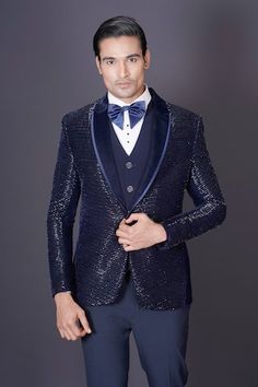 Navy blue tuxedo blazer featuring horizontal linear beaded work embroidery. Comes with a vest, white shirt, pant and a bow-tie. - Aza Fashions Festive Formal Blue Blazer, Tailored Wedding Suits With Sequins, Tailored Semi-formal Party Wear Blazer, Tailored Semi-formal Party Blazer, Elegant Blue Tuxedo For Festive Occasions, Elegant Blue Suits For Festive Occasions, Tailored Sequin Suit For Formal Occasions, Wedding Tuxedo Suit With Sequins, Fitted Wedding Blazer With Sequins