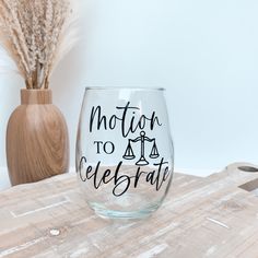 a wine glass sitting on top of a wooden table