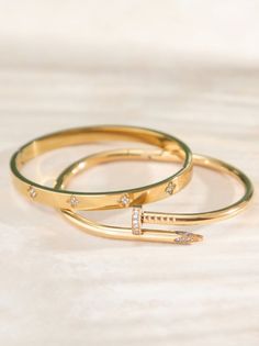 This unique wrapped nail bracelet adds an edgy touch to your look, while the clover bangle serves as an everyday staple. Nail Bangle, Gold Bracelets Stacked, Christmas Boots, Nail Bracelet, Gold Bangle, Affordable Jewelry, Bangle Set, Altar'd State, Dream Jewelry