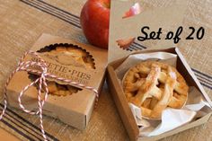 an apple pie in a box next to a paper bag with twinkies tied around it