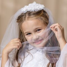 The Girls Lace Holy Communion Veil is an essential accessory for a memorable and meaningful First Communion ceremony. This delicate and elegant veil holds great significance in the Catholic tradition, symbolizing purity, reverence, and the sacredness of this special sacrament. Catholic Communion, Veiled Girl, Communion Hairstyles, Elegant Veils, First Communion Veils, Communion Veils, Cap Veil, Holy Communion Dresses, 1st Communion