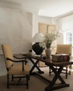 a living room with two chairs and a table