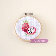 a cross - stitch pattern with a pomegranate on it