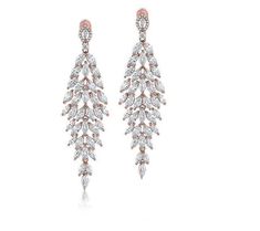 Step into a world where elegance meets glamour with these chandelier earrings. Crafted to catch the light at every turn, this stunning style features marquise-cut Diamonique simulated diamonds, gracefully suspended from a polished rosetone finish that adds a warm, radiant glow to any ensemble. Glamorous Rose Gold Dangle Chandelier Earrings, Glamorous Chandelier Earrings With Elegant Design, Stunning Style, Marquise Cut, Chandelier Earrings, A World, Prong Setting, Ear Piercings, Fashion Beauty