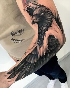 a man's arm with an eagle tattoo on it