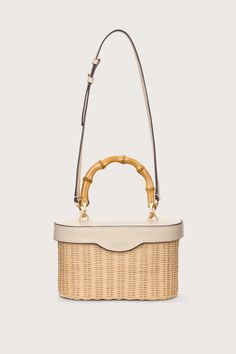 A bamboo top handle lunch box-shaped silhouette designed in a natural rattan and creamy leather. — Signature curved bamboo handle — Smooth ivory leather — Magnetic closure — Coordinating leather crossbody strap — Lined Travel Size Perfume, Bamboo Top, Summer Plans, Swimming Bag, Cult Gaia, Bamboo Handles, Orange Bag, Colored Leather, Kids Boots