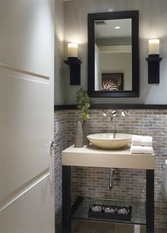 a bathroom with a sink, mirror and shower stall in it's own photo