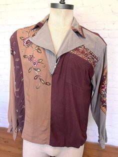 "70's long sleeve shirt Burgundy, tan and gray half zip shirt has a very unique floral design on the front, sleeve and collar. Metal zipper One front pocket One metal button at cuff Tag size Large Brand - Together! 100% Rayon Free shipping!! Measurement when laying flat across: Chest - 21.5\" Length - 26\" Sleeve - 22\"" Brown Patchwork Shirt For Fall, Bohemian Long Sleeve Brown Shirt, Bohemian Long Sleeve Fall Shirt, Bohemian Collared Shirt For Fall, Retro Long Sleeve Patchwork Shirt, Fall Vintage Print Collared Tops, Hippie Brown Long Sleeve Tops, Bohemian Collared Tops For Fall, Fall Bohemian Collared Tops