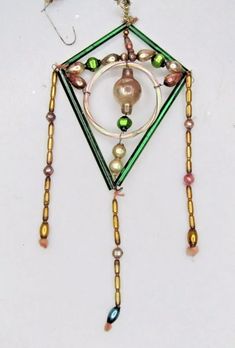 a multicolored beaded necklace hanging from a hook