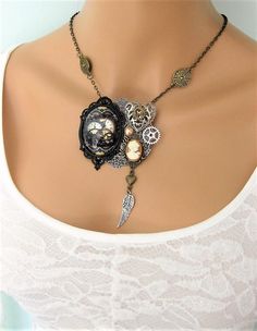 This Steampunk necklace can be interchanged to wear as a brooch too. See all the pictures. I started with a large round silver filigree piece, and added many steampunk charms, including; a large glass cabochon with steampunk gear design in black metal cabochon setting, a large antique silver metal filigree heart, caramel and ivory cameo on antique gold setting, and silver, and gold, metal steampunk gears. I added a dangle with antique gold metal heart and antique silver metal feather to the bott Steampunk Silver Jewelry For Alternative Fashion, Silver Steampunk Jewelry For Alternative Fashion, Gothic Brooch Jewelry Gift, Metal Feather, Gear Design, Filigree Heart, Steampunk Gears, Steampunk Necklace, Assemblage Jewelry