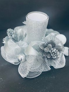 an image of a candle holder with flowers and ornaments on it's side in black and white