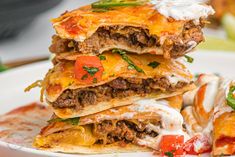 a stack of quesadillas stacked on top of each other in a white plate