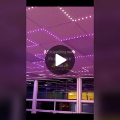 the ceiling is decorated with purple lights and stars