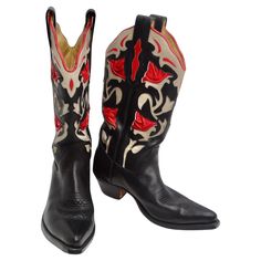 Introducing the Tony Mora Black and Red Leather Cowboy Boots, the epitome of classic Western style with a modern twist. These exquisite cowboy boots are a perfect blend of tradition and contemporary fashion, making them a must-have for anyone who loves Western vibes. These cowboy boots feature a classic black base that never goes out of style, ensuring you can wear them for years to come. The standout feature of these boots is the striking red and white leather floral detailing. This intricate design adds a touch of elegance and uniqueness to your outfit, making you stand out from the crowd. Tony Mora is renowned for its exceptional craftsmanship, and these boots are no exception. They are expertly handcrafted to perfection, guaranteeing superior quality and durability. Don't sacrifice com Black And Red Cowboy Boots Outfit, Red And Black Cowboy Boots, Flame Cowboy Boots, Red Cowboy Boots Outfit, Cowgirl Things, Blue Cowboy Boots, Red Cowboy Boots, White Cowboy Boots, Cowboy Shoes