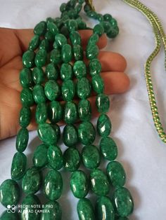 AAA 734 Carat Emerald beryl Oval Shape Fine Quality Smooth Beads With Adjustable Cord Necklace Stone : Emerald beryl Shape :- Oval Size :-6x8 - 12x17mm length - 18 inch, 3 line strings Weight :- 734 carat Polish :- Handmade color - green It is known as the 'love stone' as the message it emits is the strong vibration of unconditional love, joy, warmth and healing. As quartz crystals are profound amplifiers of energy, it may help to kindle happiness, love, romantic feelings and sensuality. It is g Elegant Emerald Necklace With Oval Gemstone Beads, Oval Green Beaded Jewelry, Green Oval Beaded Jewelry, Emerald Necklace With Oval Gemstone Beads For Jewelry Making, Oval Emerald Bead Necklace For Jewelry Making, Elegant Gemstone Oval Beads, Green Oval Gemstone Beads Necklace, Green Oval Beads With Natural Stones, Oval Green Gemstones For Jewelry Making