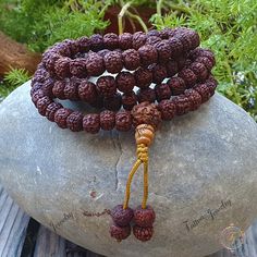 "This attractive and powerful Japa Mala is made with Rudraksha bead that are naturally stained and oiled to achieve their beautiful dark color and aged appearance. 📿Mala Beads, or Buddhist prayer beads, are a set of sacred rosary beads for chanting & counting mantras, meditation, prayer, yoga & reflection. Mala is a Sanskrit word meaning garland. The Tibetan word for mala is threngwa (Tibetan ཕྲེང་བ) . Seed malas are some of the most common malas used in Tibet and Nepal. Buddhist Prayer Beads a Spiritual Wooden Beads Bracelets For Festivals, Traditional 108 Beads Bracelet For Festivals, Spiritual Beaded Bracelets For Festivals, Traditional Bracelets With 108 Beads For Festivals, Spiritual Beaded Bracelets For Rituals, Spiritual Gemstone Beads Bracelet For Festivals, Traditional Beaded Bracelets For Meditation And Festivals, Hand Wrapped Mala With Round Beads For Meditation, Hand Wrapped Mala For Meditation