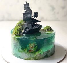 there is a cake that looks like a pirate ship on the ocean floor with moss growing on it