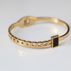 This bracelet is lightweight and easy to wear, and lend a modern edge to your jewelry wardrobe. It goes well with our BLACK GEMSTONE RING. Material: 316L Stainless Steel, 18k Gold Plated Size: 6"-7.5" Origin: California, USA Each product packed with SOCALI premium pouch and box, together with silver cleaning cloth and card. Material Our products are made from the top-grade 316L stainless steel - a metal that is nickel-free and does not fade or blacken and 100% hypoallergenic for the benefit of t Luxury Bangle With Stone Setting As Gift, Luxury Black Gold Bracelet In Classic Style, Luxury Gift Bangle For Men, Luxury Modern Black Bangle, Classic Luxury Black Gold Bracelet, Luxury Modern Black Bracelet, Luxury Black Bracelets For Everyday Luxury, Luxury Black Gold Bracelet, Luxury Adjustable Black Bangle