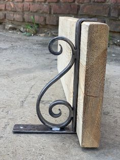 a wooden and metal object sitting on the ground