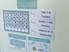 a calendar on a refrigerator door with magnets attached to the front and back of it