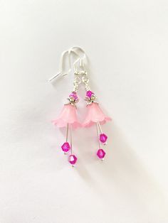 These elegant fuchsia flower Dangle Earrings are inspired by the enchanting flowers in my garden, they have been made using pretty pink lucite flowers. They have matching coloured crystals in vibrant fuchsia, these crystals are so sparkly when they move. Finished with silver fish hook ear wires and ornate floral bead caps. They are very light weight and are perfect for special occasions, thank you gifts, birthday gifts, anniversaries and yet cute enough for everyday wear.  Please note colours may vary slightly on different monitors.  ▪️ One of a kind, only one made. ▪️ lightweight and comfortable. ▪️ This item is ready for posting. ▪️ Lead and Nickel free components. ▪️ SIZE : approximately 4cm. ▪️ MATERIALS : silver wire, handmade 925 silver ear wires, genuine faceted fuchsia crystals, si Lucite Flowers, Fairy Earrings, Fuchsia Flower, Flower Dangle Earrings, Silver Fish, Handmade Jewelry Diy, Gifts Birthday, Earrings Boho, Bead Caps