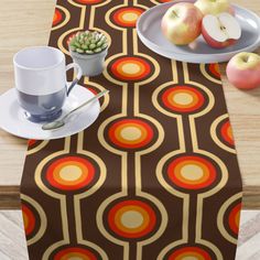 an image of a table setting with apples and coffee cup on the table cloths