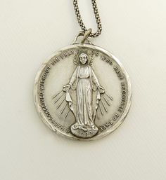 "Vintage Sterling Immaculate Mary Pendant Necklace This Lovely Vintage 1950s Religious Pendant Large Size 1.5\" Features The Immaculate Virgin Mary On The Face Standing On A Globe Surrounded By Serpents  Oh Mary Conceived Without Sin,  Pray For Us Who Have Recourse To Thee The Reverse With Immaculate Flaming Hearts & 12 Stars  The Left Heart Of Thorns Represents Jesus The Right Heart With Sword Represents Mary This Wonderful Medal Measures 1 1/4\" Round It Hangs From An 18\" Sterling Silver Chai Vintage Miraculous Medal Necklace As Gift, Vintage Miraculous Medal Necklace Gift, Vintage Necklace With Round Miraculous Medal, Vintage Round Necklace With Miraculous Medal, Vintage Round Miraculous Medal Necklace, Vintage Necklaces With Miraculous Medal, Vintage Miraculous Medal Necklace, Vintage Miraculous Medal Round Pendant Jewelry, Collectible Jewelry With Miraculous Medal Round Pendant