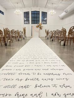 a large white sheet with writing on it in a room full of chairs and chandeliers