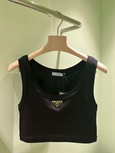 Made from soft cotton jersey, this tank-style crop top is a menswear-inspired design with a feminine touch. This piece features Prada's iconic triangular logo plaque in gold finish.All items are brand new & 100% authentic guaranteed. DETAILS100% cottonHand washMade in ItalyBlack Need assistance? Use our Sourcery service or speak to a member of our team via WhatsApp Prada Items, Prada Crop Top, Celine Crop Top, Prada Tank Top, Celine Clothes, Prada Outfits, Prada Clothes, Prada Brand, Prada Top