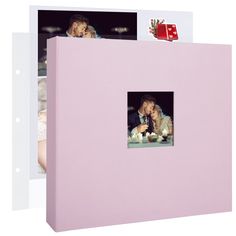 a couple kissing in front of a pink box with photos on it and a christmas present hanging from the top